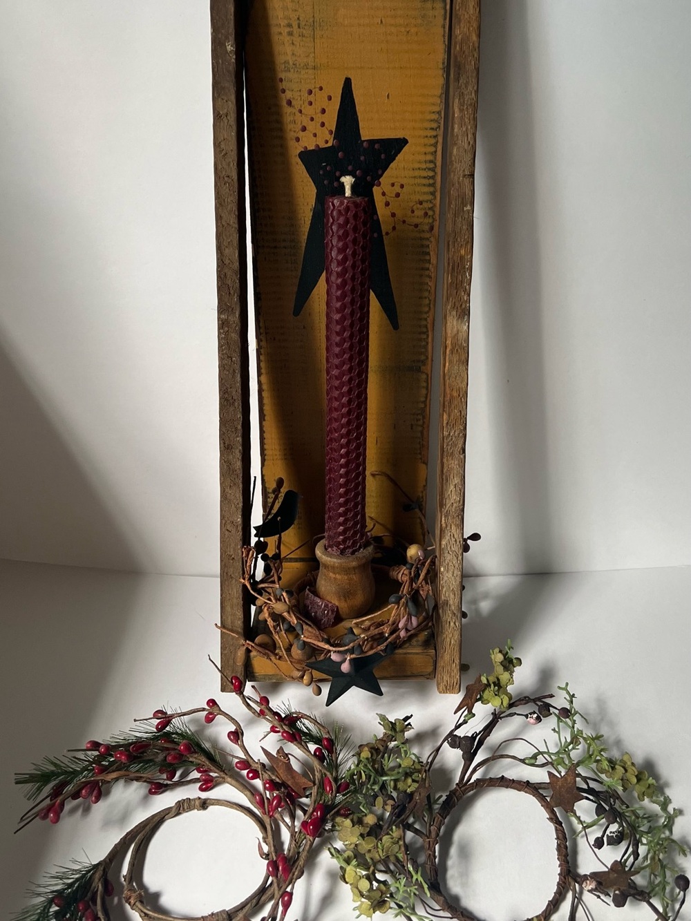 Primitive candle holder with Taper Candle and three changeable mini wreaths.